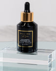 A black bottle with a dropper of Cocomero Watermelon Glow Serum with Hyaluronic Acid, labeled with the brand Bella Vida Santa Barbara luxury skincare, and an award badge for 'Beauty Shortlist Editor's Choice 2024'. The product is described as helping to achieve a glow and radiance for the skin.