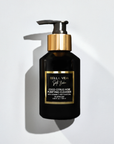 A black bottle with a gold pump labeled 'Coco Citrus Noir Purifying Cleanser' by Bella Vida Santa Barbara.