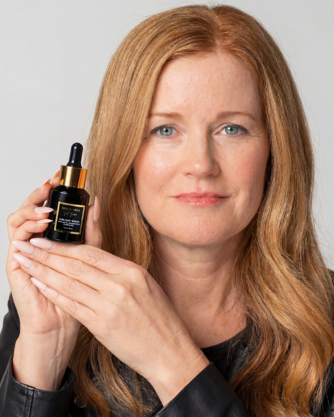 Founder of Bella Vida Santa Barbara holding the Sunlight Serum with peptides and bakuchiol