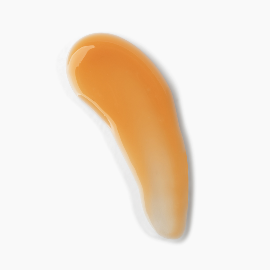 Nude-colored lip oil smear on a white background