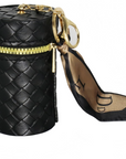 Black woven cylindrical pouch with gold zipper and matching strap on a white background